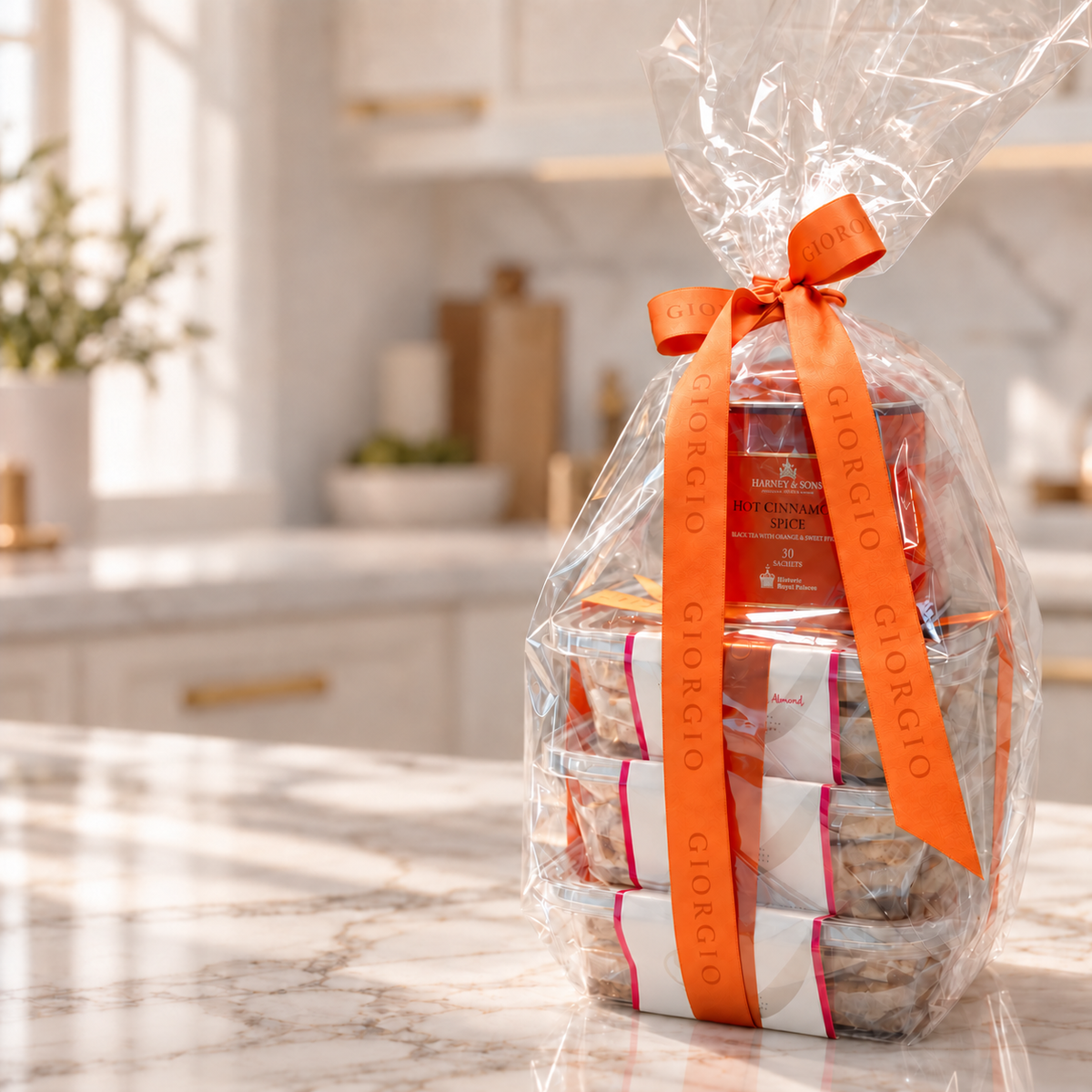 A round pack of Giorgio cookies tied with an embossed ribbon on a silver gift box