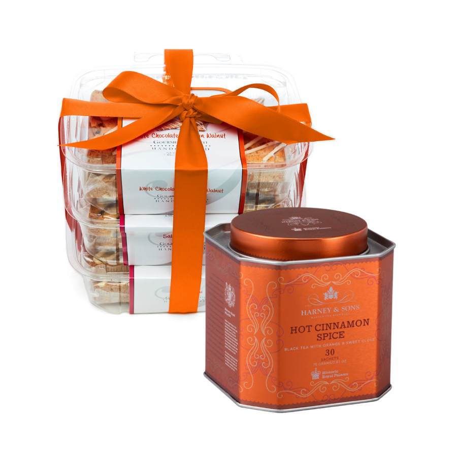 What's inside the Tea + Biscotti Gift Set: a Harney & Sons Hot Cinnamon Spice tea tin and three Giorgio biscotti packs tied with a burnt orange ribbon